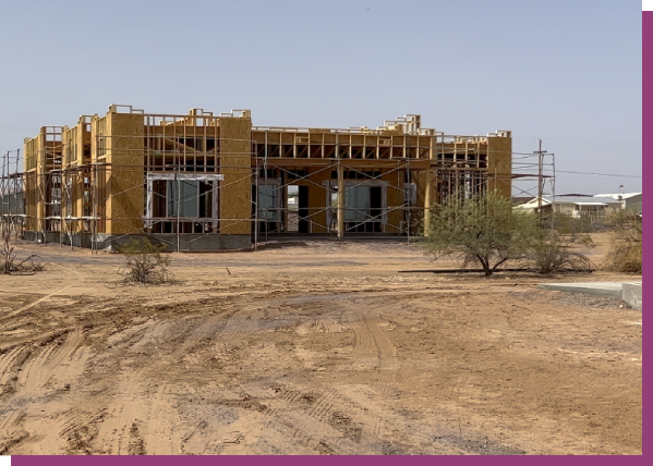 A building under construction in the desert.